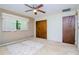Bedroom with ceiling fan and large windows providing natural light at 15350 Scanio Dr, Spring Hill, FL 34610
