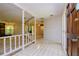 Bright entryway with tiled floors and white balustrade at 15350 Scanio Dr, Spring Hill, FL 34610