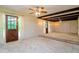 Living area with wood beams, carpet, and multiple doors at 15350 Scanio Dr, Spring Hill, FL 34610