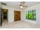 Bright bedroom with wood closet doors and view of backyard at 15350 Scanio Dr, Spring Hill, FL 34610