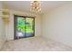 Spacious bedroom with sliding glass doors leading to the backyard at 15350 Scanio Dr, Spring Hill, FL 34610