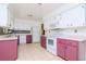 Efficient kitchen with purple cabinets and white appliances at 15350 Scanio Dr, Spring Hill, FL 34610
