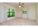 Bright bedroom with large windows and a ceiling fan at 15350 Scanio Dr, Spring Hill, FL 34610