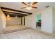 Living room with wood beam ceilings and a view of the kitchen at 15350 Scanio Dr, Spring Hill, FL 34610