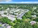 An aerial view of a neighborhood showcasing lush trees, roads, buildings, and parking lots at 1433 S Belcher Rd # G10, Clearwater, FL 33764