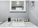 A bathroom featuring a marble countertop with silver-tone fixtures at 1433 S Belcher Rd # G10, Clearwater, FL 33764