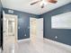 Bedroom featuring modern ceiling fan, closet, doors to bathroom and walk-in closet, and light flooring at 1433 S Belcher Rd # G10, Clearwater, FL 33764