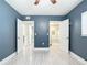 Bedroom with light-colored flooring, doors to bath and closets, and a ceiling fan at 1433 S Belcher Rd # G10, Clearwater, FL 33764