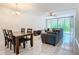 Bright living room and dining area with light floors and modern sliding glass doors for natural light and views at 1433 S Belcher Rd # G10, Clearwater, FL 33764