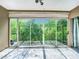 Bright sunroom featuring large sliding glass doors offering an expansive view of the backyard at 1433 S Belcher Rd # G10, Clearwater, FL 33764