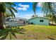 Large backyard with grassy area and a screened-in pool at 1549 Linwood Dr, Clearwater, FL 33755