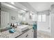 Bright bathroom with a granite vanity, a vessel sink, and a shower-tub combo at 1549 Linwood Dr, Clearwater, FL 33755