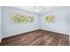 Bright bedroom featuring wood floors and two windows at 1549 Linwood Dr, Clearwater, FL 33755