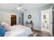 Bright bedroom boasts wood floors, a ceiling fan, and an ensuite bathroom at 1549 Linwood Dr, Clearwater, FL 33755