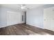 Spacious bedroom featuring wood floors, a ceiling fan, and closet doors at 1549 Linwood Dr, Clearwater, FL 33755