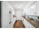Bright kitchen features white cabinets, granite countertops, and modern appliances at 1549 Linwood Dr, Clearwater, FL 33755