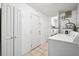 Laundry room with tile floor, a washer, dryer, and storage cabinets at 1549 Linwood Dr, Clearwater, FL 33755
