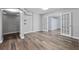 Spacious living room featuring modern flooring, shelving and double doors at 1549 Linwood Dr, Clearwater, FL 33755