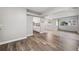 Bright living room with wood-look floors and access to the kitchen at 1549 Linwood Dr, Clearwater, FL 33755
