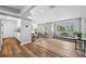 Open-concept living room with hardwood floors, brick fireplace and lots of natural light at 1549 Linwood Dr, Clearwater, FL 33755