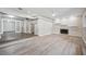 Bright living room with fireplace and white stone facade and elevated floor dining area in a well lit home at 1549 Linwood Dr, Clearwater, FL 33755