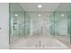 Bathroom with large mirrored wall, white jacuzzi tub, and recessed lighting at 1560 Gulf Blvd # 1004, Clearwater Beach, FL 33767