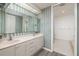 Bathroom with double vanity, striped wallpaper, and walk-in shower at 1560 Gulf Blvd # 1004, Clearwater Beach, FL 33767