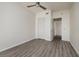 Empty bedroom with gray wood-look floors, ceiling fan, and closet at 1560 Gulf Blvd # 1004, Clearwater Beach, FL 33767