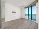 Bedroom with wood-look flooring, ceiling fan, and ocean view through sliding door at 1560 Gulf Blvd # 1004, Clearwater Beach, FL 33767