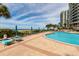 Beachfront pool with lounge chairs and umbrellas at 1560 Gulf Blvd # 1004, Clearwater Beach, FL 33767