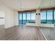 Living room featuring large windows with stunning ocean views and a mirrored wall at 1560 Gulf Blvd # 1004, Clearwater Beach, FL 33767