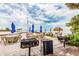 Beachfront grilling area with picnic tables and umbrellas at 2506 N Rocky Point Dr # 356, Tampa, FL 33607