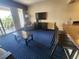 Living room features a TV, comfy seating, and access to a balcony at 2506 N Rocky Point Dr # 356, Tampa, FL 33607