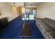 Living room with sofa, coffee table, and access to balcony with ocean view at 2506 N Rocky Point Dr # 356, Tampa, FL 33607