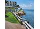 Scenic waterfront path with rocks and lush green grass at 2506 N Rocky Point Dr # 356, Tampa, FL 33607