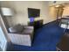Living area with comfortable armchair and flat-screen TV at 2506 N Rocky Point Dr # 356, Tampa, FL 33607
