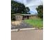 One-story house with overgrown lawn and driveway at 385 Dolphin Se Ave, St Petersburg, FL 33705