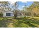 House exterior showcasing a screened pool and backyard at 10208 Grove Dr, Port Richey, FL 34668