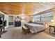 Bright bedroom featuring a king-size bed and wood paneled ceiling at 10208 Grove Dr, Port Richey, FL 34668