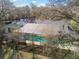 House with a screened-in pool and lush trees at 10208 Grove Dr, Port Richey, FL 34668