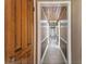 Long hallway with wood-paneled ceiling and updated flooring at 10208 Grove Dr, Port Richey, FL 34668