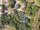 House nestled in a wooded area with a pool at 10208 Grove Dr, Port Richey, FL 34668