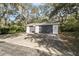 Two-car garage with dark gray doors and basketball hoop at 10208 Grove Dr, Port Richey, FL 34668