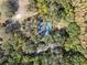 Aerial view of home with pool in wooded area at 10208 Grove Dr, Port Richey, FL 34668