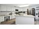 Spacious kitchen with white cabinets, granite counters, and island at 10208 Grove Dr, Port Richey, FL 34668