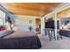 Bedroom with wood ceiling, full-size bed, and large mirror at 10208 Grove Dr, Port Richey, FL 34668