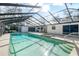 Inviting pool and spa with a screened enclosure at 10208 Grove Dr, Port Richey, FL 34668
