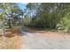 Driveway approaching home with wooden fence at 10208 Grove Dr, Port Richey, FL 34668