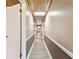 Long hallway with wood-look floors and wood ceiling at 10208 Grove Dr, Port Richey, FL 34668