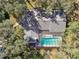 An aerial view showcasing a home with a private pool at 10208 Grove Dr, Port Richey, FL 34668